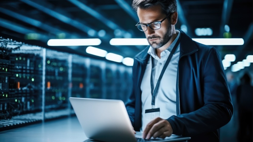 A man looks down his laptop.