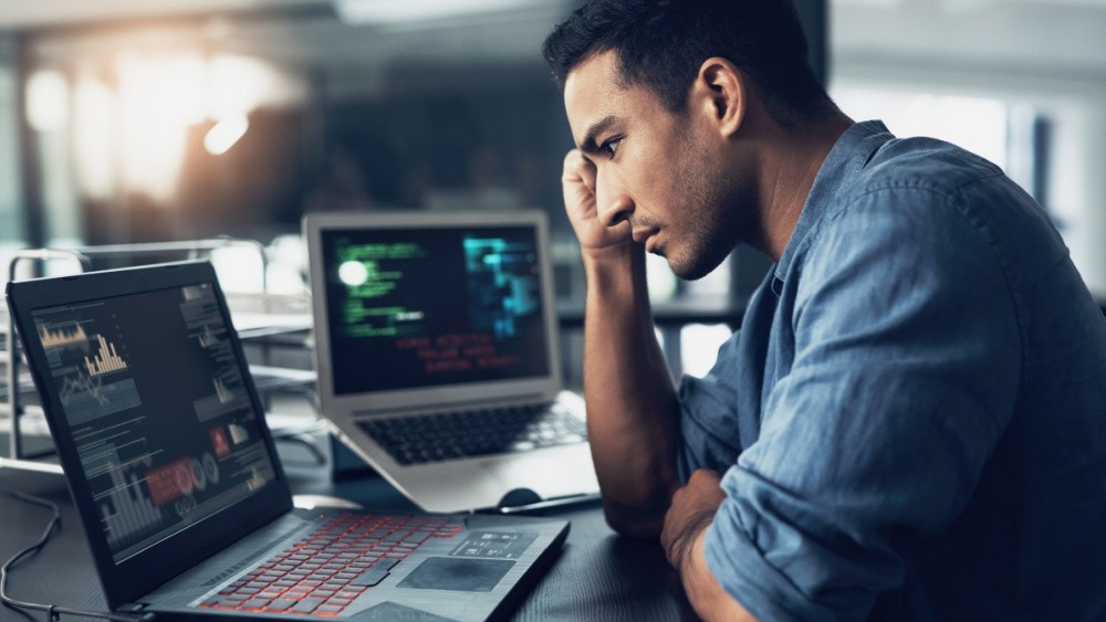 A man in front of a laptop.