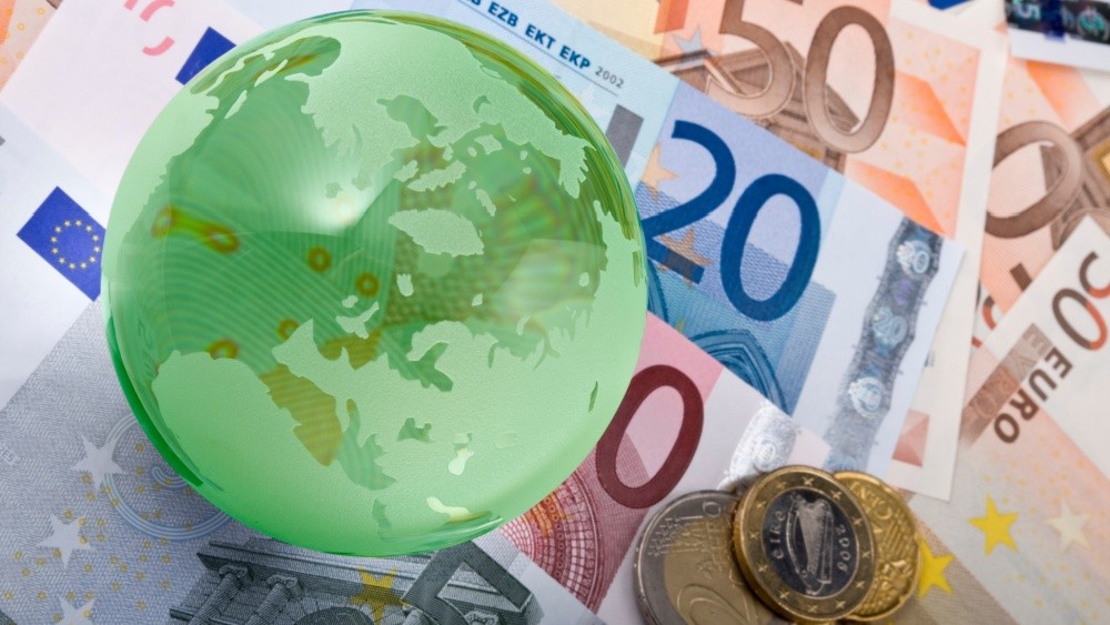 A glass globe placed on euro bills.