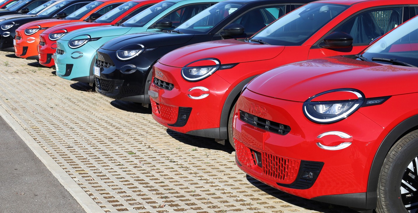 New Fiat 600 cars lined up by the dealership.