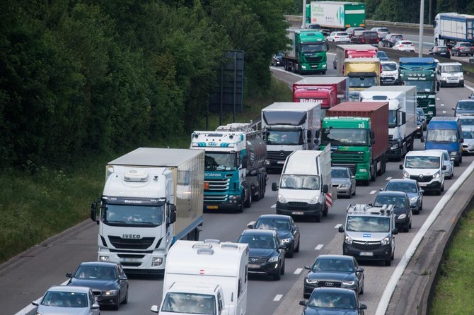 Busses, commercial vehicles, vans and lorries driving on a motorway